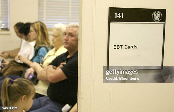 Displaced people by Hurricane Katrina wait to receive an Emergency Benefits Transaction card at the Louisiana State Building in Shreveport, on...