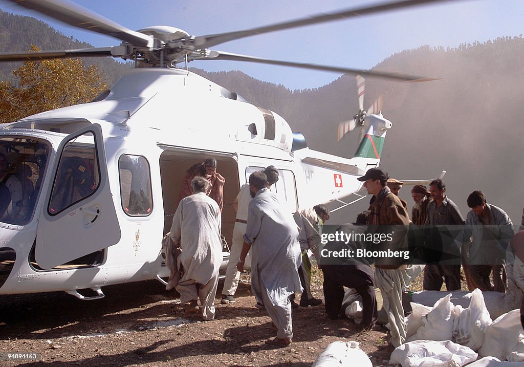 Villagers unload earthquake relief supplies in Dali, norther