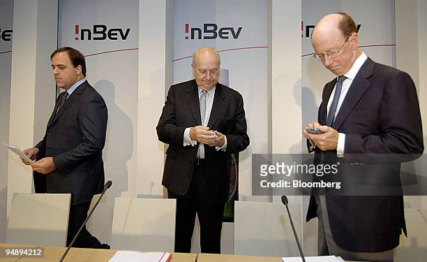 Felipe Dutra, left, chief financial officer of InBev, Pierre Jean Everaert, center, chairman and John Brock, chief executive pause prior to a press...