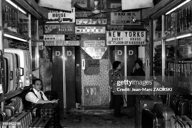 Homme et femme asiatiques dans leur commerce de valises, 1978 a Hong Kong.