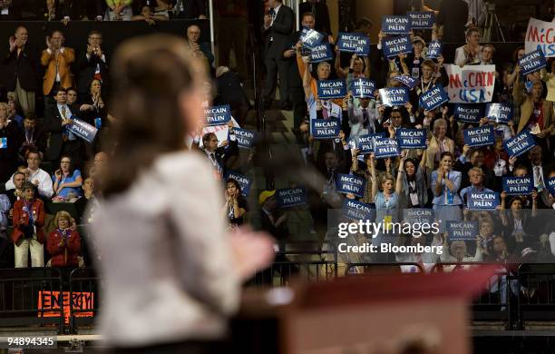 Supporters hold signs as Sarah Palin, governor of Alaska and vice presidential running mate of Senator John McCain of Arizona, Republican...