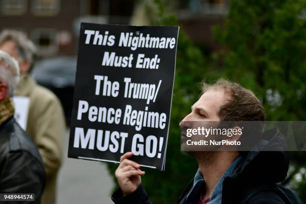 Anti-Trump sign is held by a protestor participating as community members join religious leaders and clergymen with Philadelphians Organized to...
