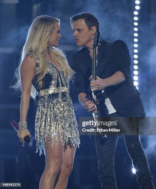 Carrie Underwood and guitarist Ed Eason perform during the 53rd Academy of Country Music Awards at MGM Grand Garden Arena on April 15, 2018 in Las...