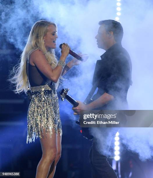 Carrie Underwood and guitarist Ed Eason perform during the 53rd Academy of Country Music Awards at MGM Grand Garden Arena on April 15, 2018 in Las...