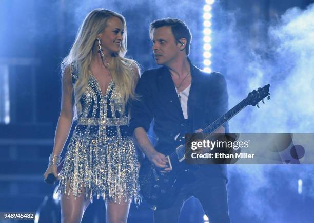 Carrie Underwood and guitarist Ed Eason perform during the 53rd Academy of Country Music Awards at MGM Grand Garden Arena on April 15, 2018 in Las...