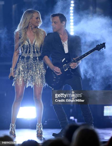 Carrie Underwood and guitarist Ed Eason perform during the 53rd Academy of Country Music Awards at MGM Grand Garden Arena on April 15, 2018 in Las...