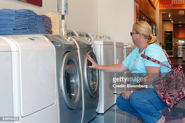 Debbie Pike, a Hurricane Katrina evacuee from Ocean Springs, Mississippi, looks at a washer-dryer set at the Maytag Store in Hoover, Alabama...