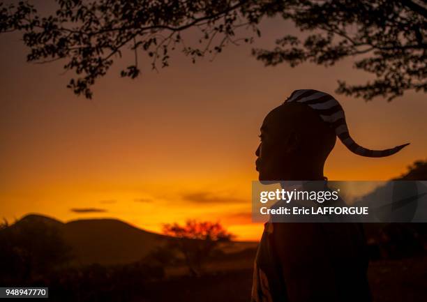 Himba man silhouette in the sunset, epupa, Namibia on March 3, 2014 in Epupa, Namibia.