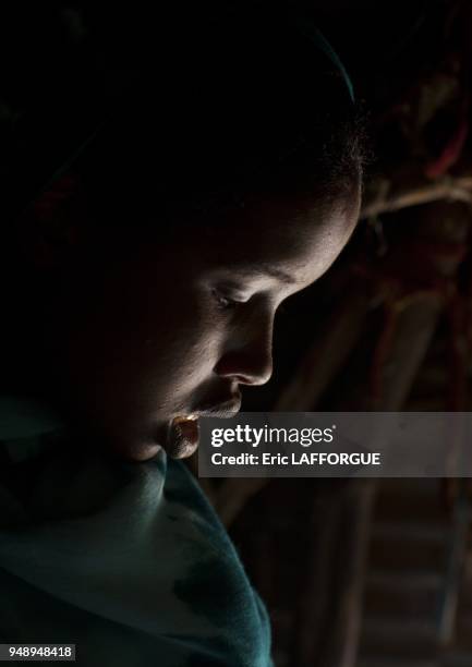 Profile Portrait Of Bended Haed Teenage Girl In Half Light Hargeisa Somaliland.