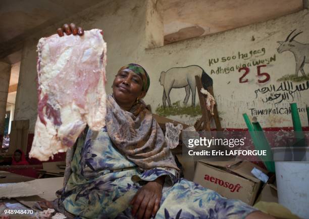 Woman Mean Vendor Holding Piece Of Livestock In Hand, Hargeisa, Somaliland.