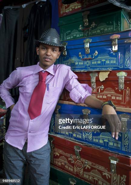 Man With Hat Standing In Front Of Chest Vendor Stall, Hargeisa Market, Somaliland.