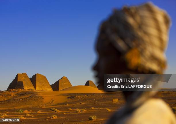 Kid in front of the pyramids and tombs in royal cemetery, meroe, Sudan on March 7, 2013 in Meroe, Sudan.