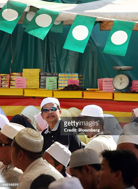 Crowd of Muslims gather to listen to Nik Aziz Nik Mat, the Pan-Malaysian Islamic Party's spiritual leader and chief minister of Kelantan state, as he...