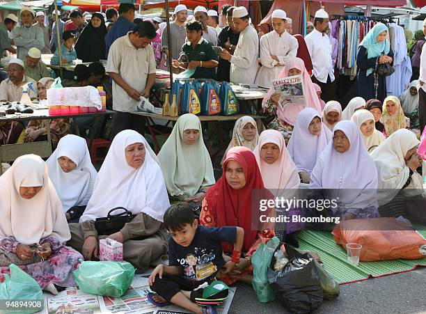 Crowd of Muslims gather to listen to Nik Aziz Nik Mat, the Pan-Malaysian Islamic Party's spiritual leader and chief minister of Kelantan state, as he...