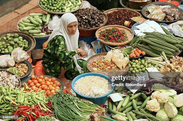 Vegetable vendor sits amongst her produce at the market in Kota Bharu, Kelantan, Malaysia, on Friday, Feb. 22, 2008. In the northeastern Malaysian...