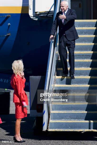 Senator John McCain of Arizona, Republican presidential candidate, right, waves to his wife Cindy as he arrives in Minneapolis, Minnesota, U.S., on...