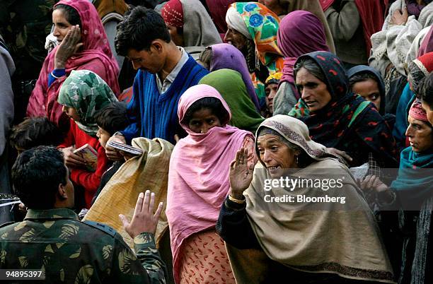 Woman earthquake survivor argues with an Indian Army Officer as she waits for relief material in Kamal Kote village near the Line of Control, in the...