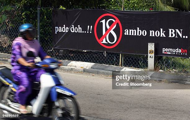 Motorist drives past an election banner for the Barisan Nasional party in Kota Bharu, Kelantan, Malaysia, on Thursday, Feb. 21, 2008. In the...