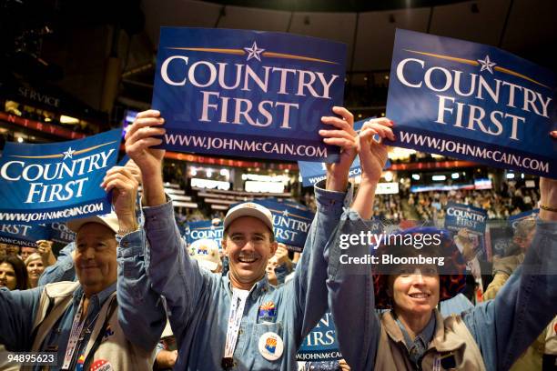 Delegates hold up signs reading "Country First," the campaign slogan of Senator John McCain of Arizona, Republican presidential candidate, on day two...