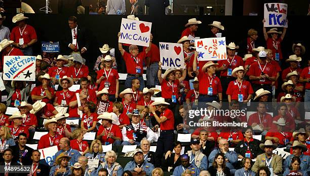 Attendees from Texas hold up signs in support of Senator John McCain of Arizona, Republican presidential candidate, on day two of the Republican...