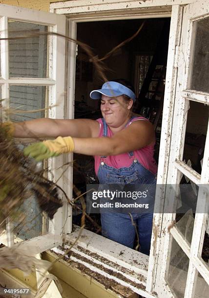 Tina Rodgers throws trash out a broken window while salvaging whatever she can from her aunt s house in Gulfport, Mississippi on Tuesday, September...