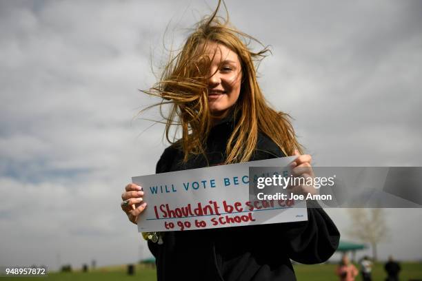 10th grader Caitlyn Bedenbender 16, of Littleton with her sign as students from Marjory Stoneman Douglas High School, Pittsburgh, Columbine as well...