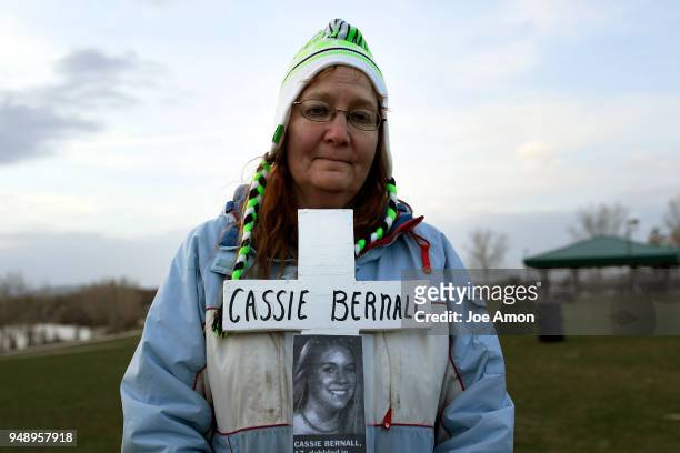 Rhonda Grindle carries a memorial cross for Cassie Bernall 17, as students from Marjory Stoneman Douglas High School, Pittsburgh, Columbine as well...