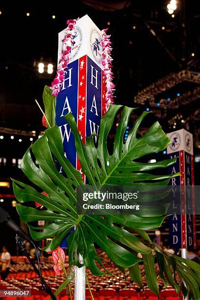 Palm frond and lei hang from a sign marking the section for Hawaii delegates on day two of the Republican National Convention at the Xcel Center in...