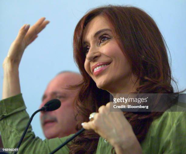Argentina's First Lady Cristina Fernandez de Kirchner waves during a press conference after winning a seat in the Senate in elections in Buenos Aires...