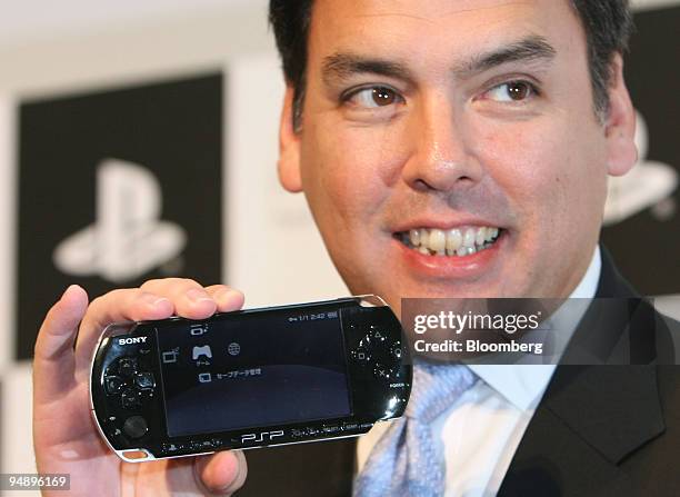 Shawn Layden, head of the Japan at Sony Computer Entertainment Inc., shows off the company's PlayStation Portable "PSP-3000" player at a news...