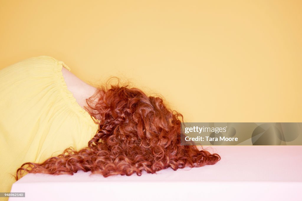 Woman with head on table