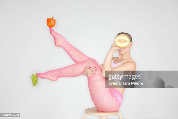 woman balancing fruit and vegetables on body - fine furniture photos et images de collection