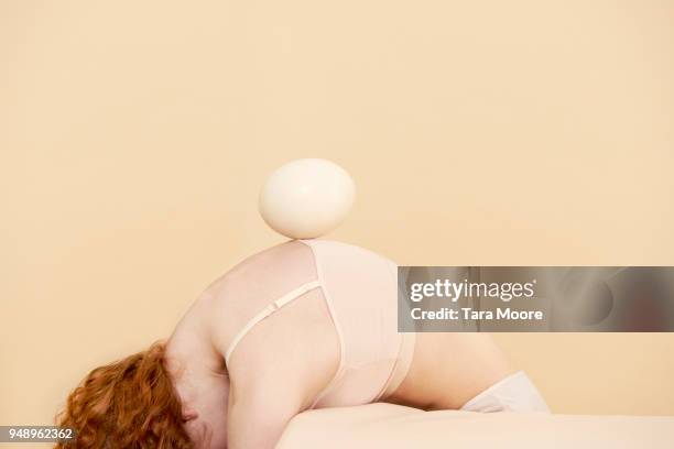 woman balancing egg on back - animal stage stockfoto's en -beelden