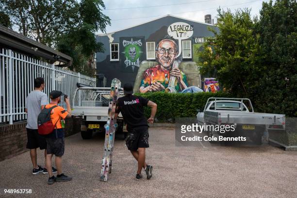 Political mural artist, Scott Marsh looks at his work after painting a mural of Senator Richard Di Natale in the Sydney suburb of Newtown on April...