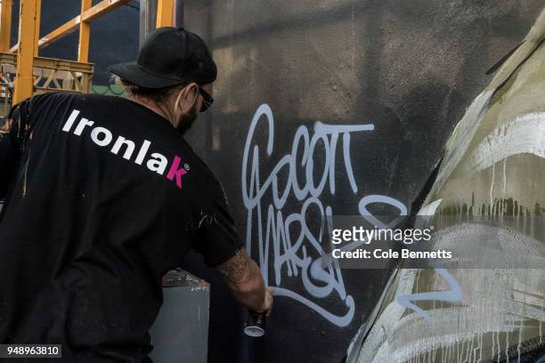Political street artist, Scott Marsh signs a mural of Senator Richard Di Natale in the Sydney suburb of Newtown on April 20, 2018 in Sydney,...