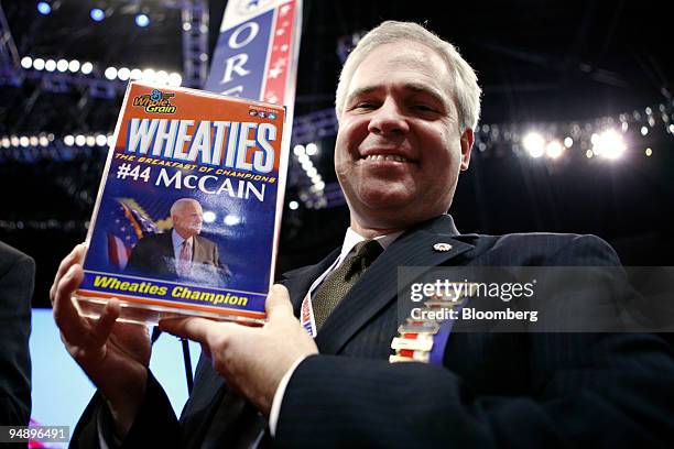 Vance Day, chairman of Oregon Republican National Committee, displays a box of Wheaties cereal with a photo of Senator John McCain of Arizona,...