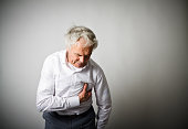 Old man with chest pain suffering from heart attack.