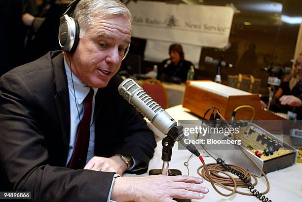 Democratic Presidential candidate Howard Dean answers callers questions during a radio program with host Ed O'Brien at a Holiday Inn in Manchester,...