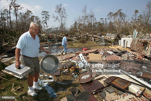 Jerry Delchamps carries pots and pans he has salvaged from his hurricane destroyed home in Waveland, MS. Friday, September 2, 2005.