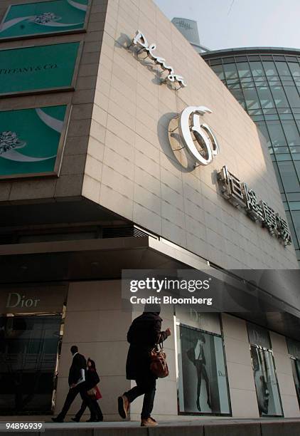 Pedestrians walk in front of Plaza 66, developed by Hang Lung Properties Ltd. In Shanghai, China, on Wednesday, Feb. 20, 2008. Hang Lung Properties...