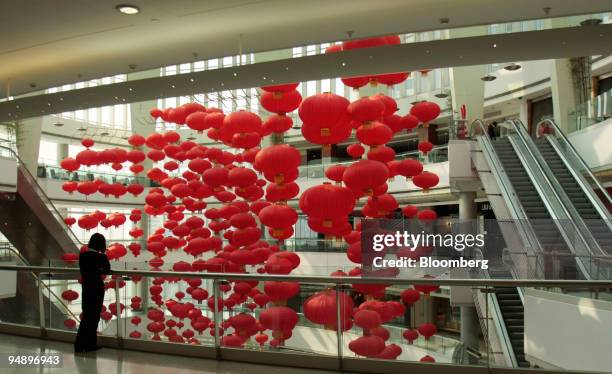 Woman uses her mobile phone inside Plaza 66, developed by Hang Lung Properties Ltd. In Shanghai, China, on Wednesday, Feb. 20, 2008. Hang Lung...