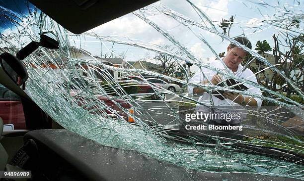 Jon Frederickson, an Allstate catastrophic claims adjuster, assesses the damage to a vehicle owned by Gil Iles of Punta Gorda, Florida, on Tuesday,...