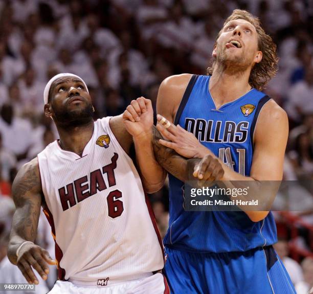 LeBron James, left, and Dirk Nowitzki jockey for position under the basket during Game 6 of the NBA Finals between the Miami Heat and the Dallas...