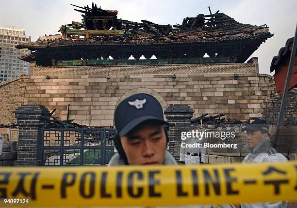 Police seal off the area around Sungnyemun Gate, also called Namdaemun, or South Gate, in Seoul, South Korea, on Monday, Feb. 11, 2008. Fire...