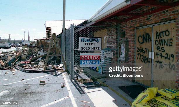The insurance company and policy numbers of a feed store partially destroyed by Hurricane Charley are written on the door in Arcadia, Florida, August...