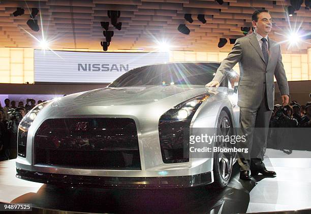 Nissan Motor Co. Chief executive Carlos Ghosn poses with the GT-R Proto concept coupe at the Tokyo Motor Show Wednesday, October 19, 2005.