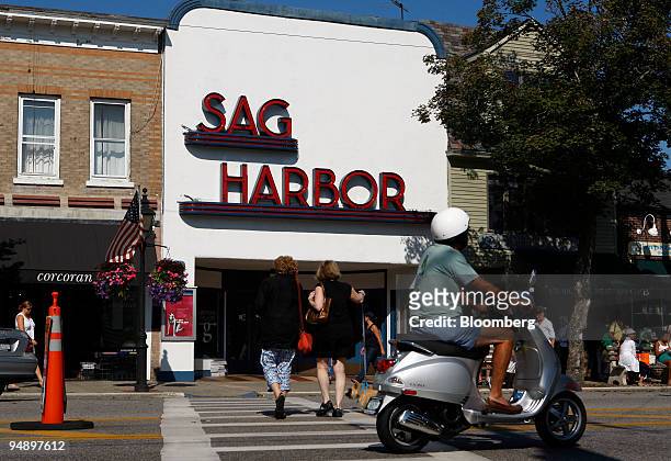 Scooter drives by the Sag Harbor Cinema on Main Street in Sag Harbor, New York, U.S., on Sunday, Aug. 31, 2008. The business district of the town is...