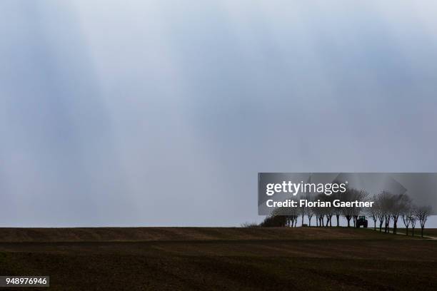 Tractor drives along a track across the fields on April 13, 2018 in Zittau, Deutschland.