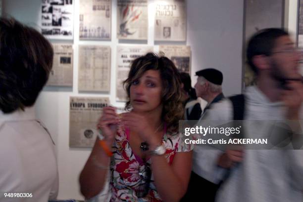 Woman shows her emotion as she views concentration camp photos of victims which is one of the many exhibits at the Yad Vachem Holocaust Museum in...