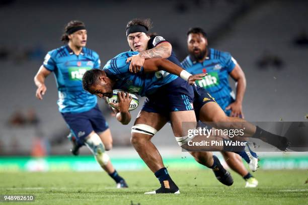 Patrick Tuipulotu of the Blues is tackled during the round 10 Super Rugby match between the Blues and the Highlanders at Eden Park on April 20, 2018...